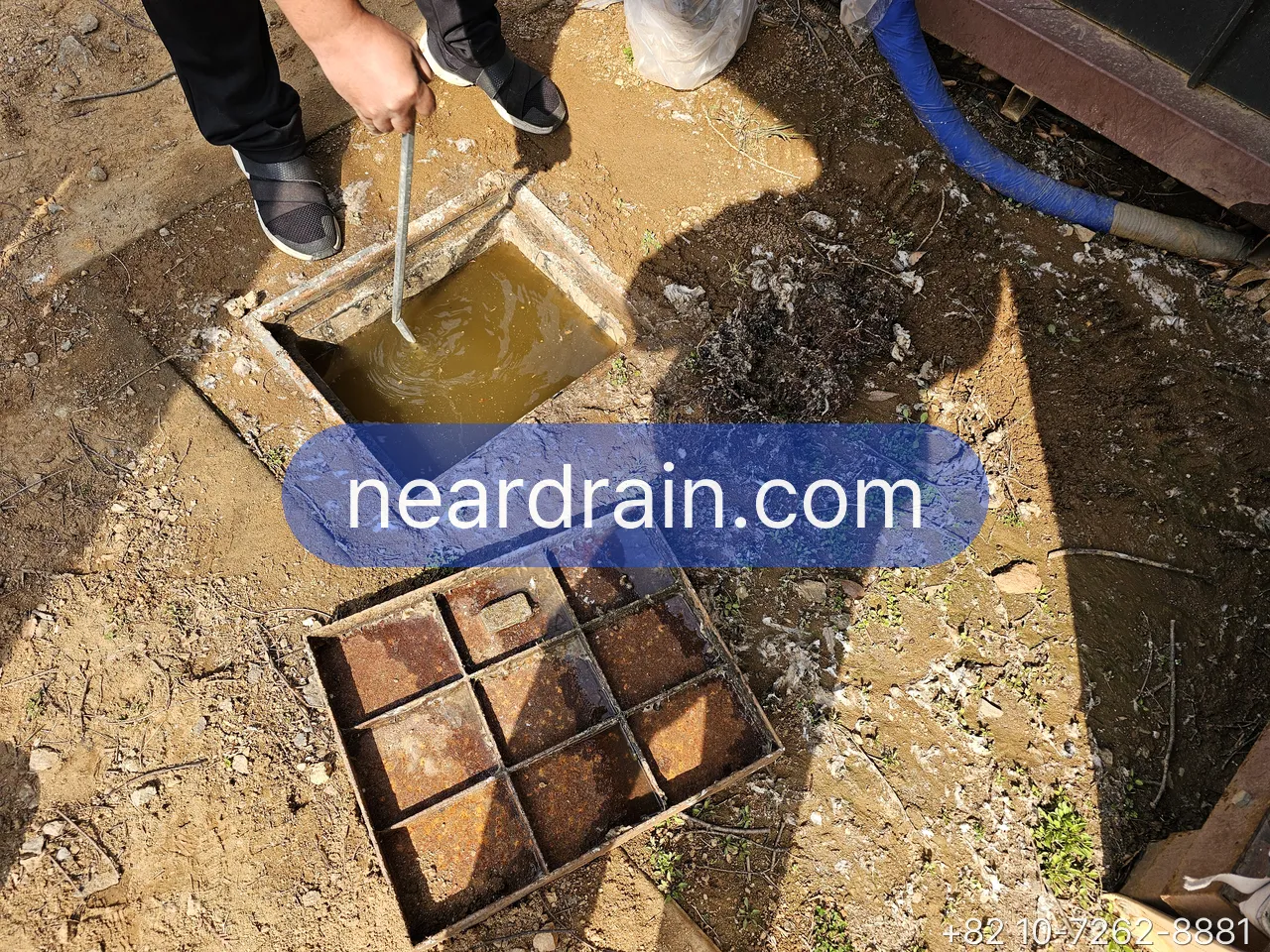 Courtyard trench drain being cleaned out