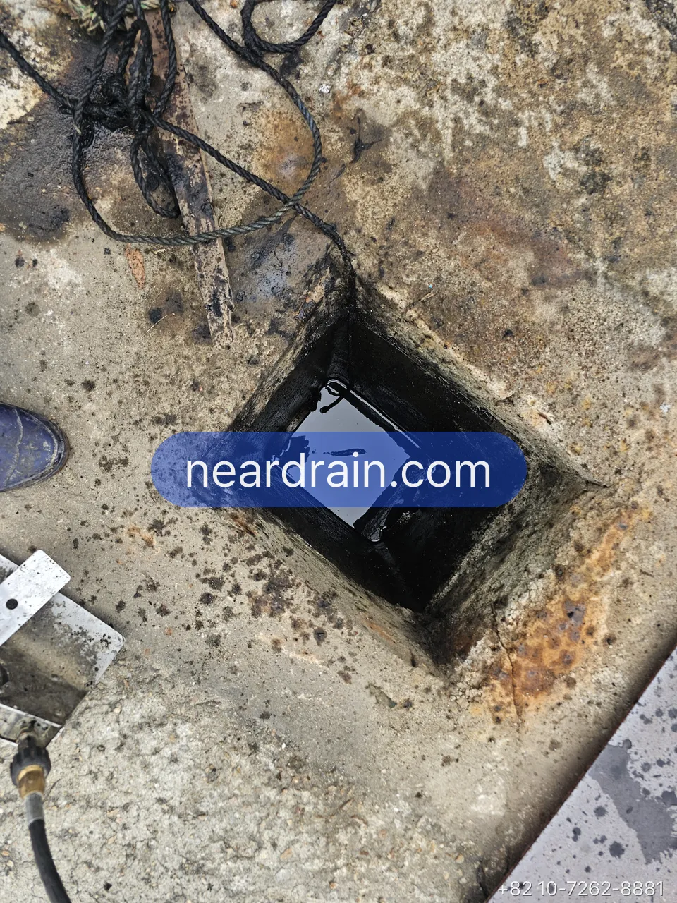 Basement floor pit with the pump power and float cables running into it
